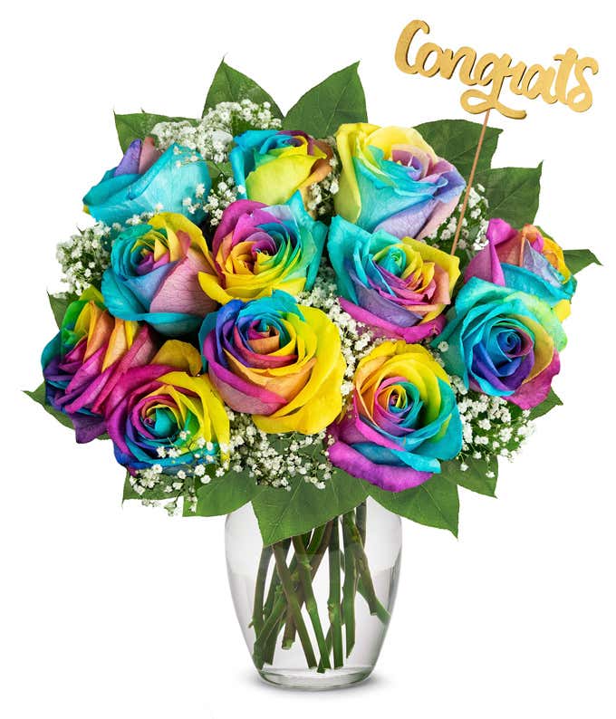 Bouquet of one dozen vibrant wild rainbow roses with optional elegant glass vase and personalized gift message for a housewarming.