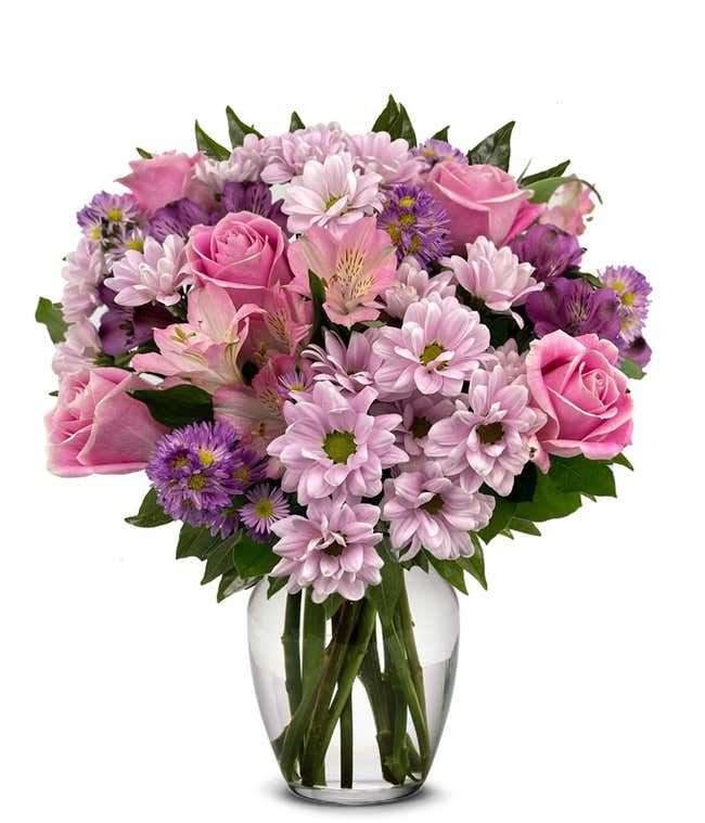 A vibrant arrangement featuring pink roses, purple daisies, pink alstroemeria, purple alstroemeria, and purple Monte Casino, optionally arranged in a vase. This colorful mix offers a cheerful and lively display.