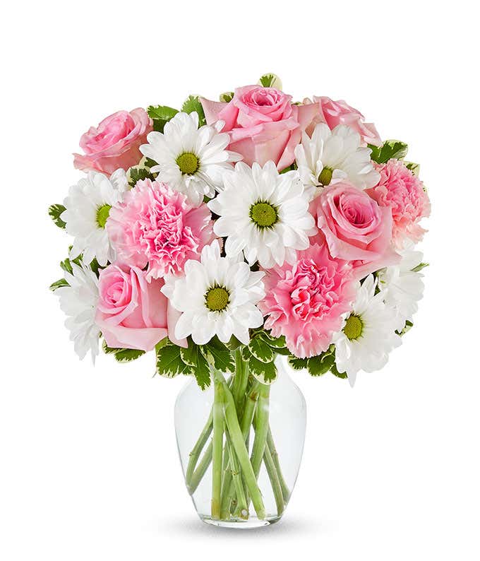 Floral arrangement featuring pink roses, white daisies, and pink carnations, optionally in a vase.