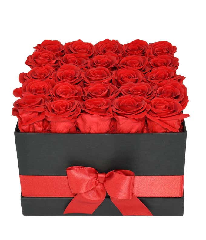 25 preserved red roses arranged into a black hat box with a red ribbon.