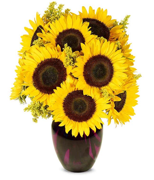 Bouquet of vibrant sunflowers arranged in a clear glass vase.