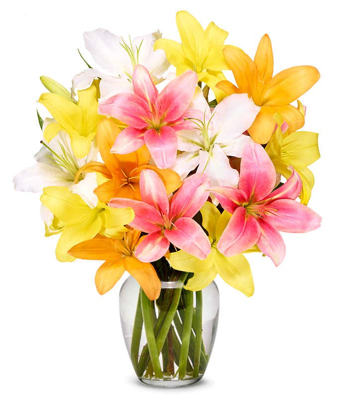 A vibrant floral arrangement featuring pink lilies, orange lilies, and yellow lilies.