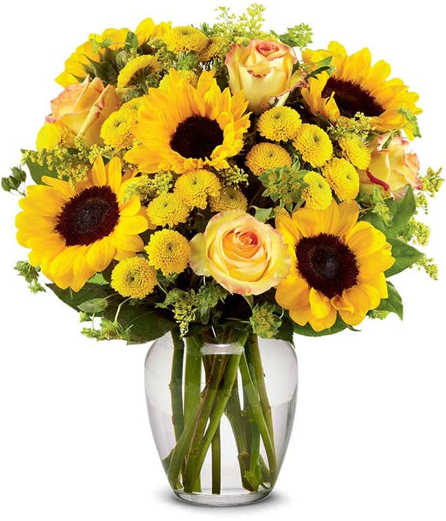 A vibrant arrangement featuring yellow/orange bi-color roses, sunflowers, yellow button poms, yellow solidago, and bupleurum, optionally presented in a vase. This cheerful display brings a burst of sunshine and joy to any occasion.