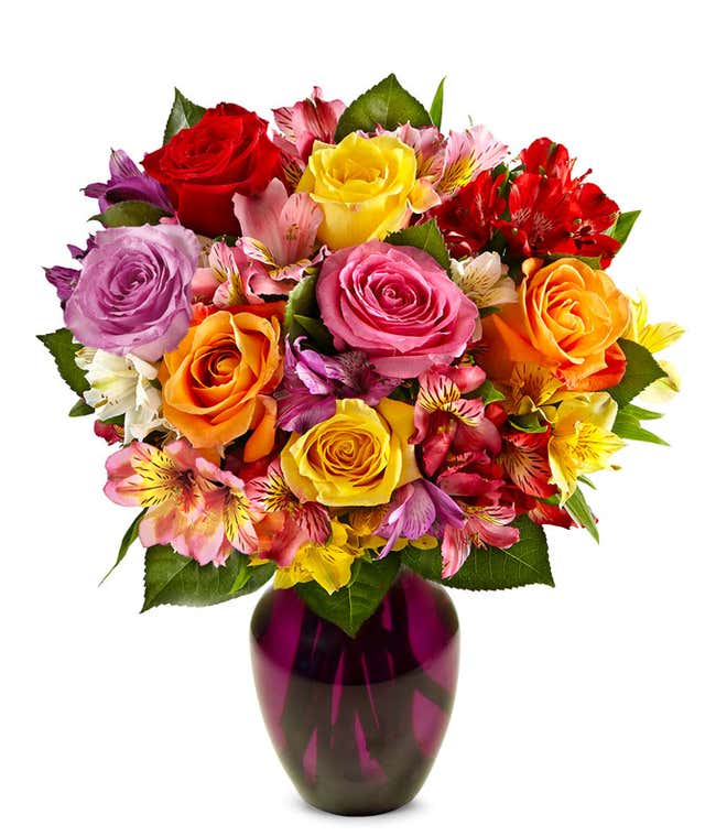 A beautiful arrangement featuring mixed roses and assorted alstroemeria, optionally presented in a glass vase. This vibrant mix offers a colorful and cheerful display, perfect for any occasion.