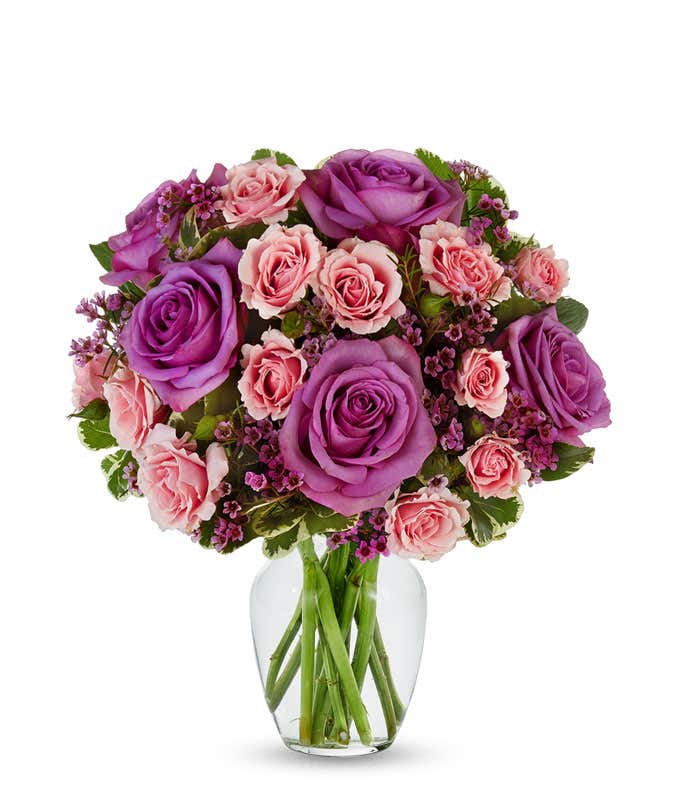 Purple roses paired with pink spray roses