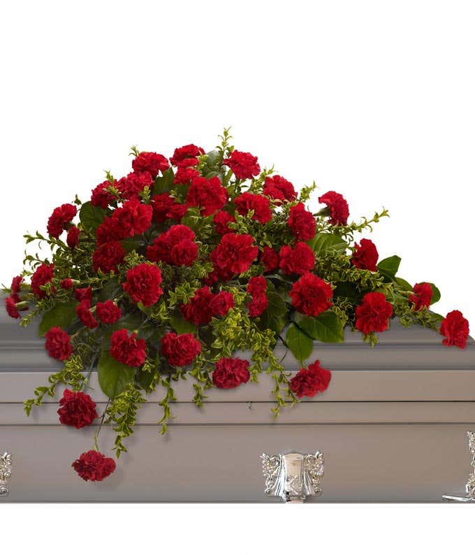 Casket Spray: Red carnations, red miniature carnations, and floral greenery, symbolizing love and remembrance.