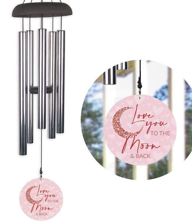 Wind chime with a sail that reads Love You to the Moon and Back, in shades of pink and red.